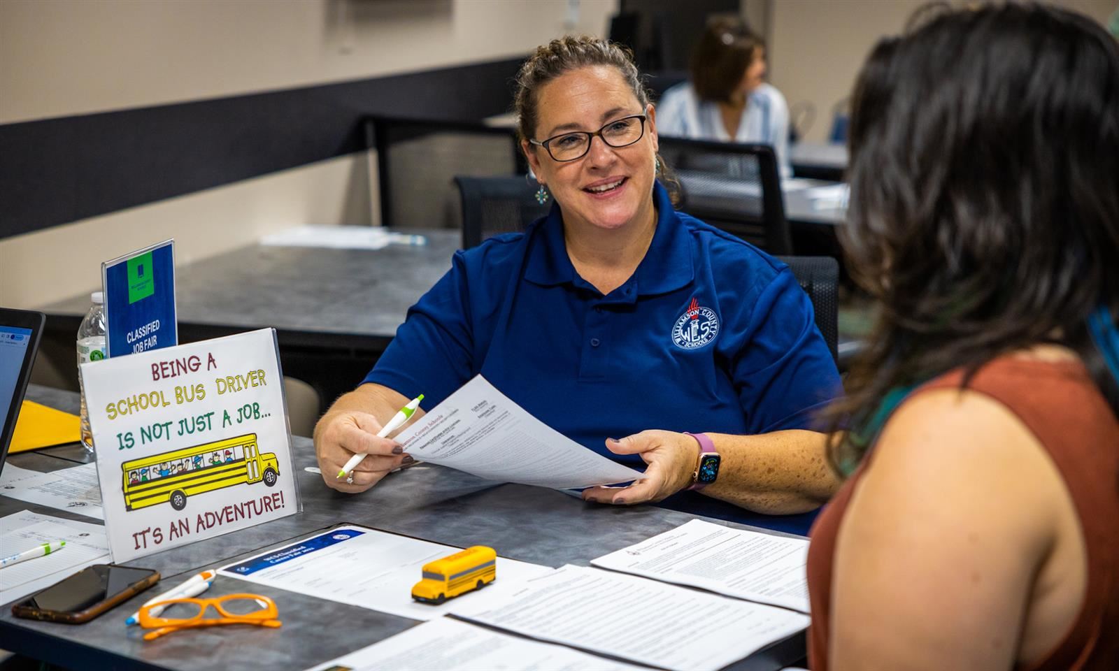A Food Services employee speaks with a potential applicant